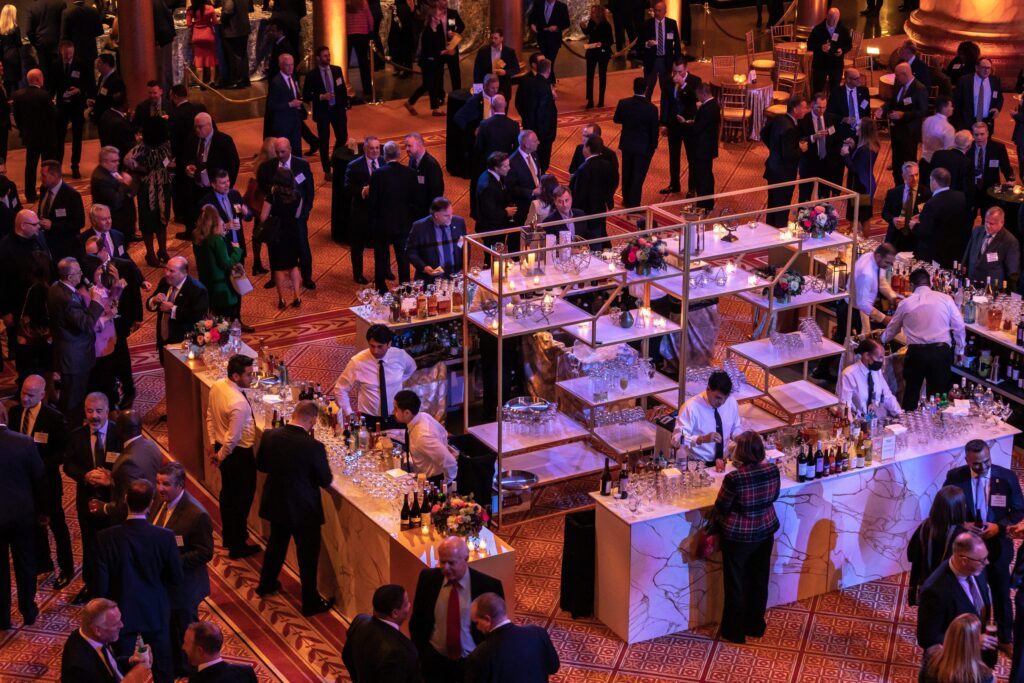 a large group of people standing around tables