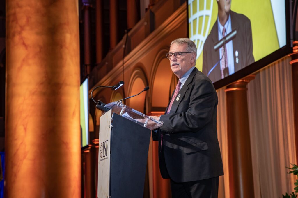 a man standing at a podium giving a speech
