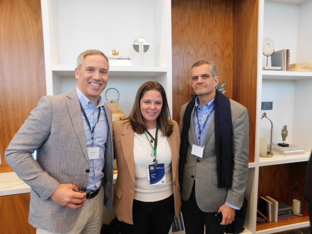 two men and a woman standing next to each other