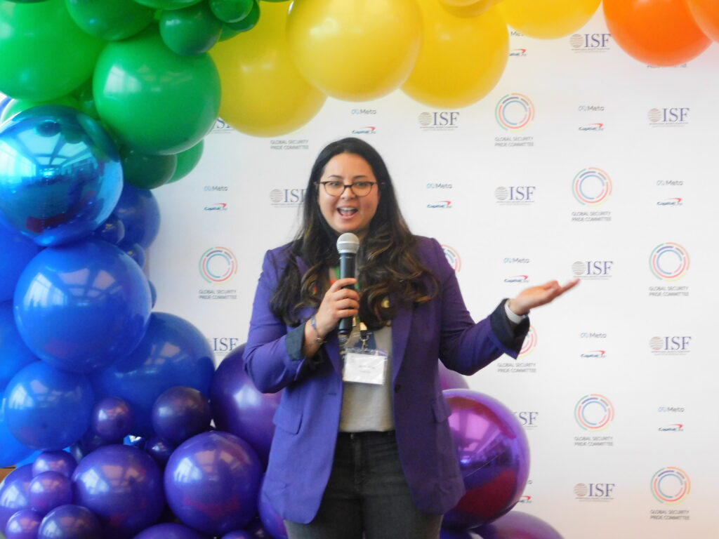 a woman speaking into a microphone in front of balloons