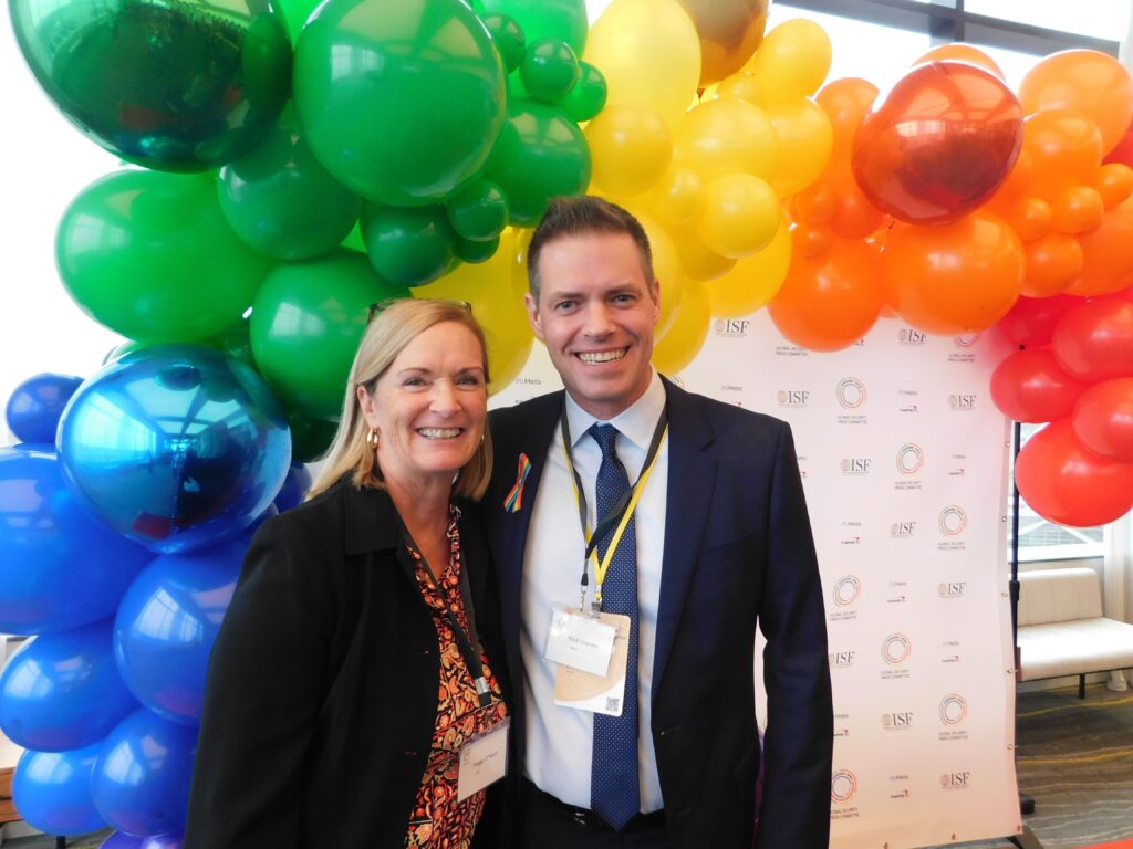 a man and woman standing in front of balloons