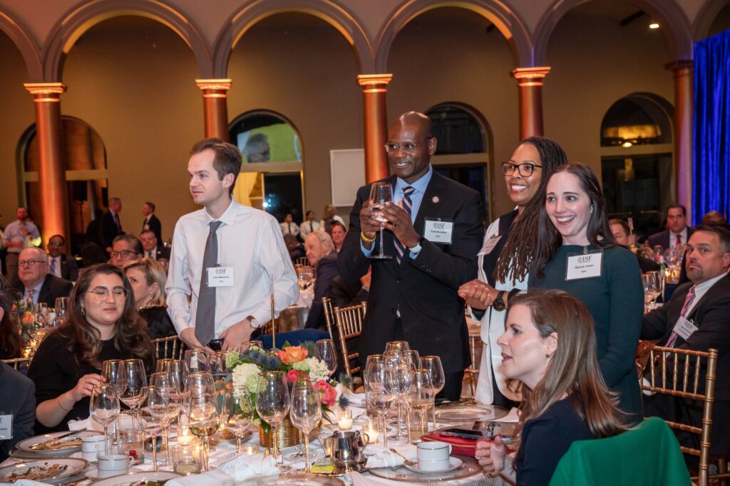 a group of people sitting around a table with wine glasses