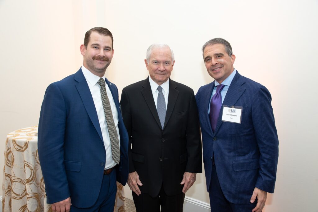 three men standing next to each other in suits