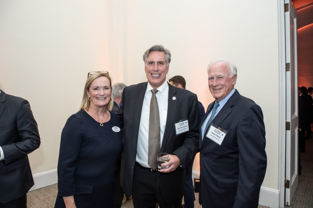 three people standing next to each other smiling