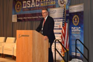 a man in a suit and tie standing at a podium