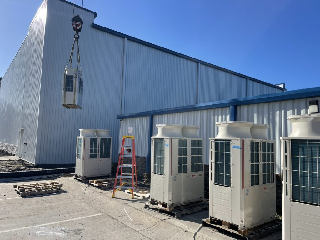 a row of air conditioning units in front of a building