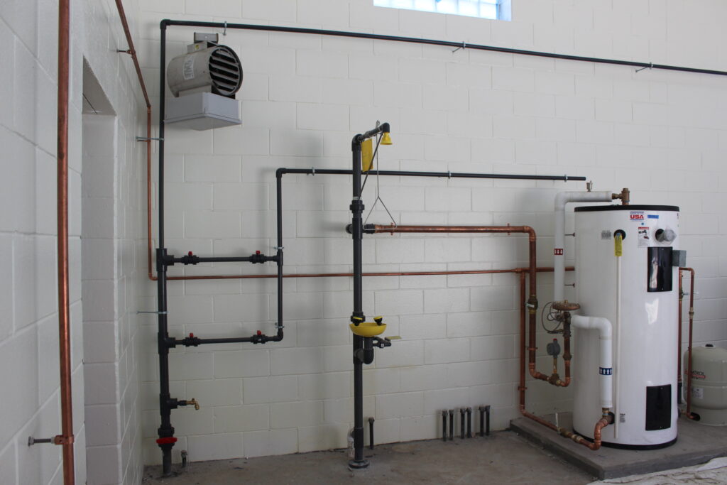 a room with pipes and a water heater