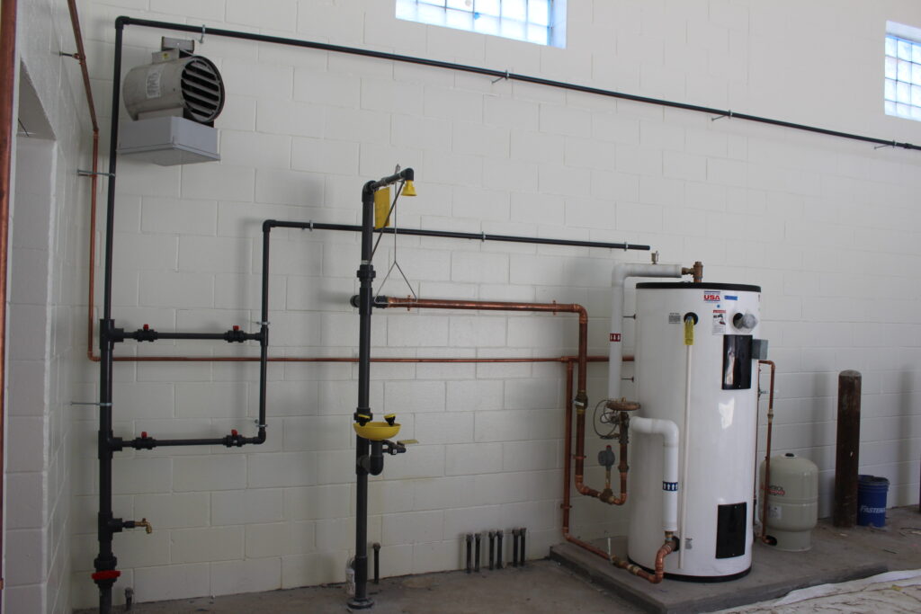 a room with pipes and a water heater