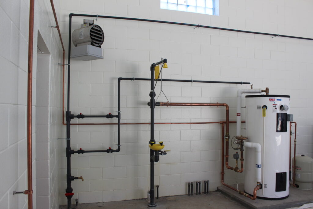 a room with pipes and a water heater