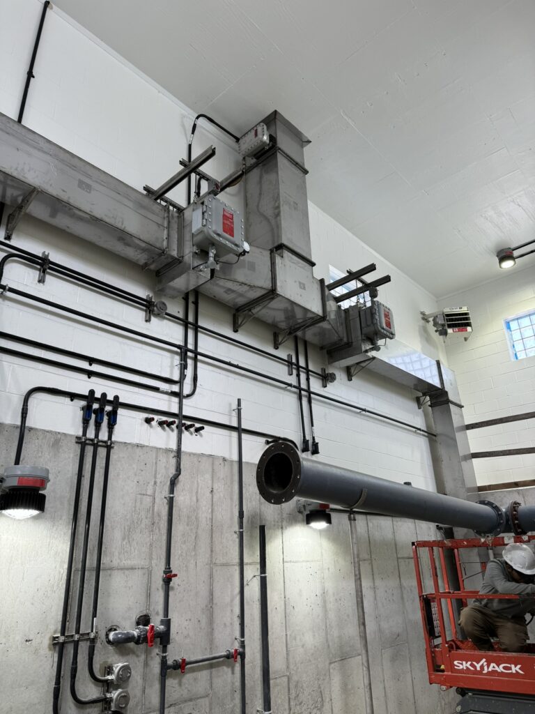 a man working on a pipe in a building