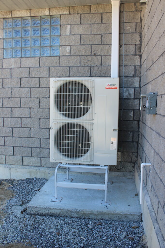 a couple of air conditioners on the side of a building
