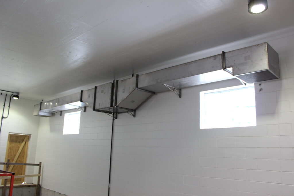 a room that has a metal shelf on the wall