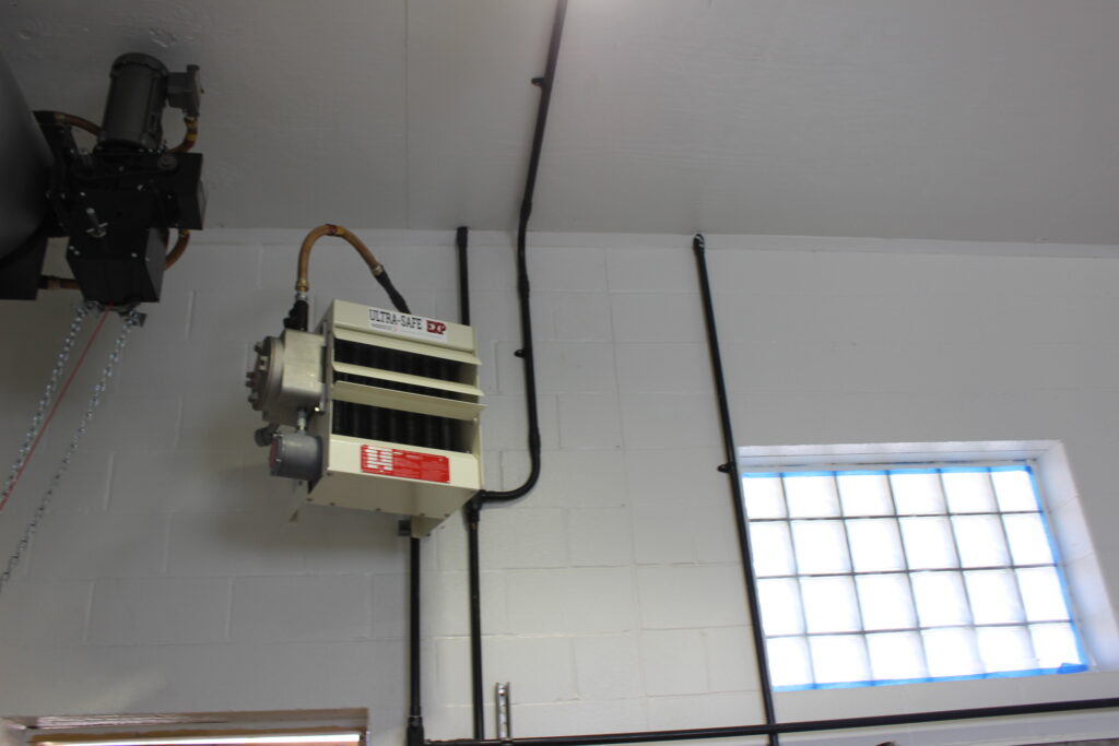 a room with a window and a machine hanging from the ceiling