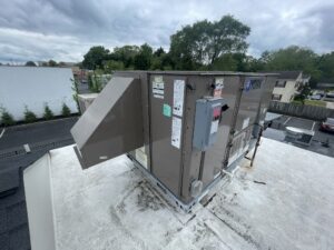 the roof of a building with a metal box on top of it