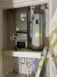 a water heater and a ladder in a room