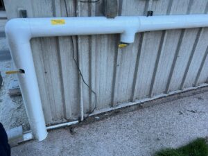 a white pipe on the side of a building