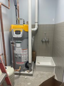 a bathroom with a water heater and a toilet