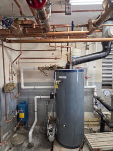 a room with pipes and a water heater