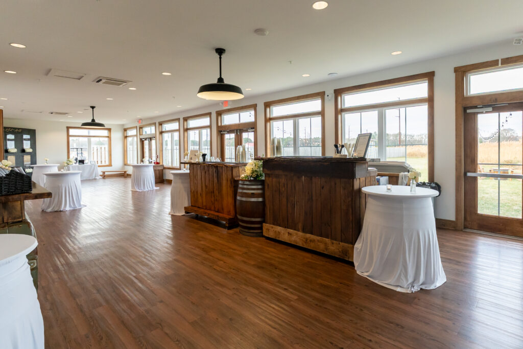 The double live edge bar set up for cocktail hour in the sunporch of the Pole Barn at King Cole Farm.