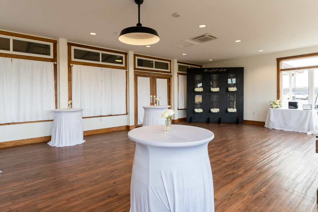 View #2: Bud Vases and a candle sitting on multiple covered cocktail barrels in the sunporch at King Cole Farm.