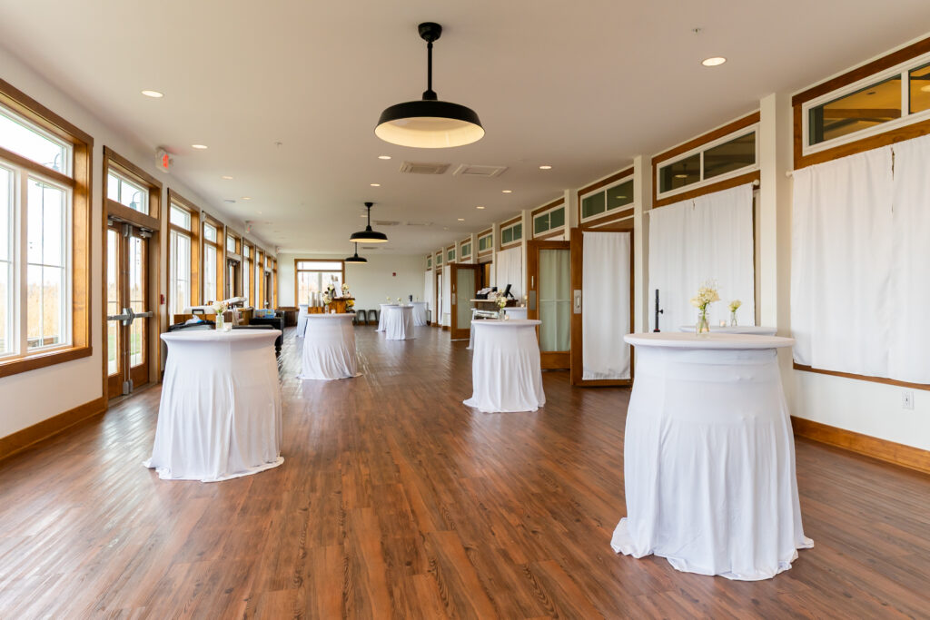 View #1: Bud Vases and a candle sitting on multiple covered cocktail barrels in the sunporch at King Cole Farm.