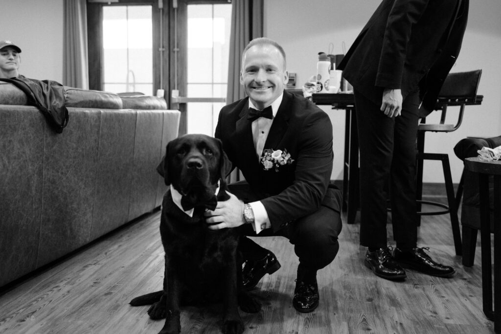A groom and his dog in the groom's lodge in the Pole Barn at King Cole Farm.