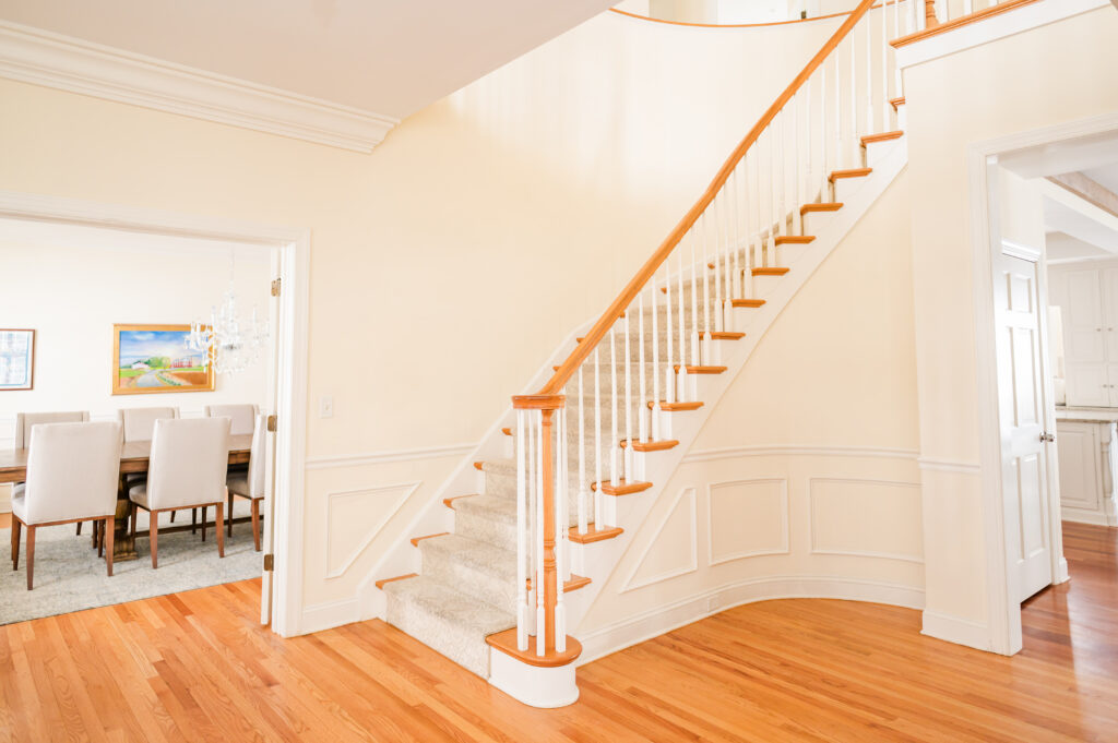The main staircase and entrance to the formal dining room at The Residence at King Cole Farm.