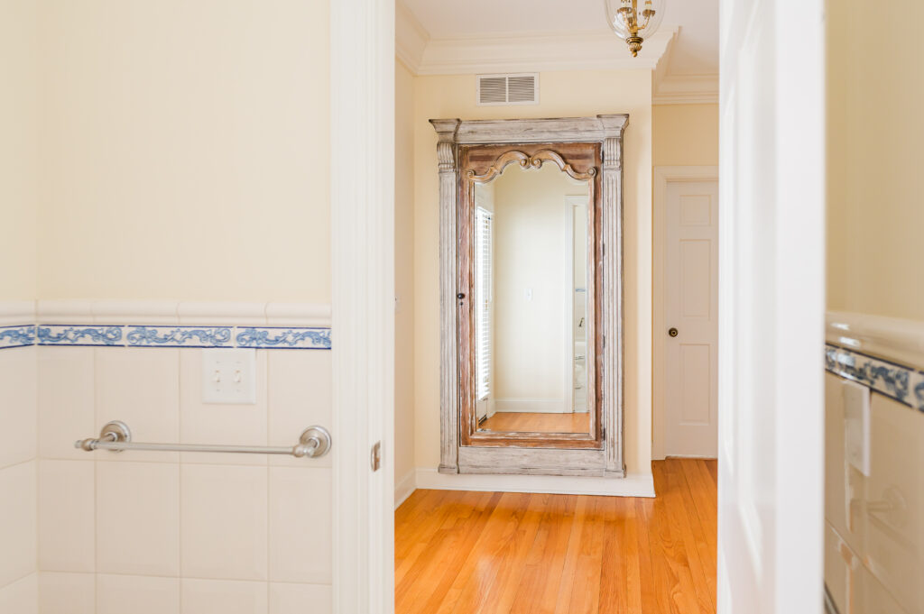 Image looking out of the bridal suite bathroom to the jewelry mirror in the balcony in The Residence at King Cole Farm.