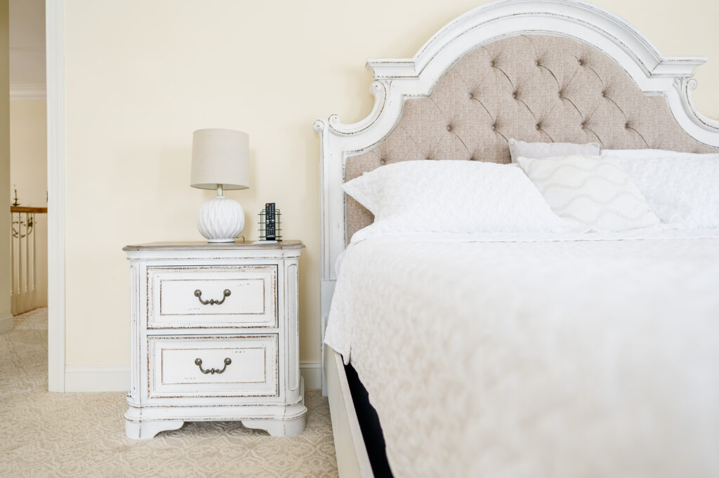 Image of the bed and nightstand in the bridal suite bedroom at King Cole Farm