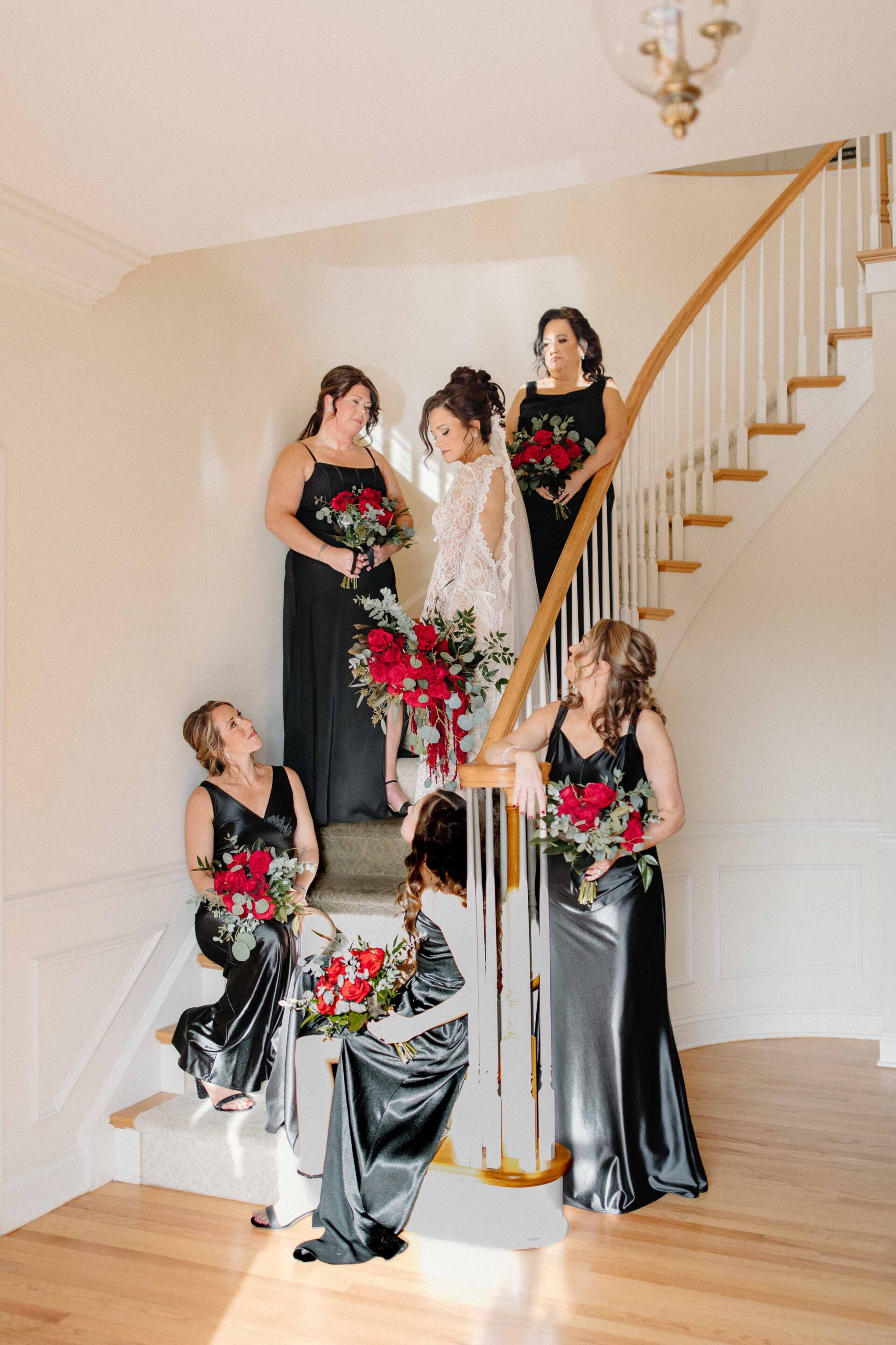 bride with bridemaids standing on stairway