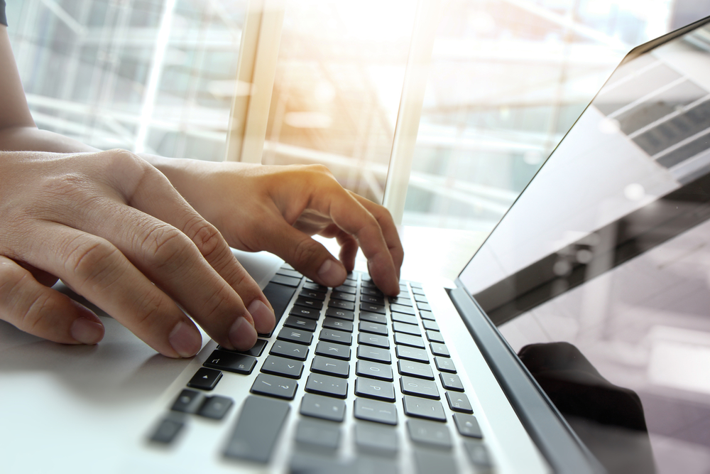 a person typing on a laptop computer