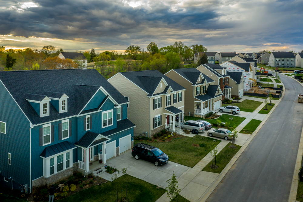 a neighborhood with many houses and cars parked on the street