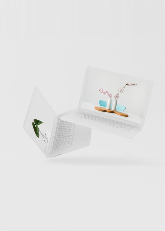 an open laptop computer sitting on top of a white surface