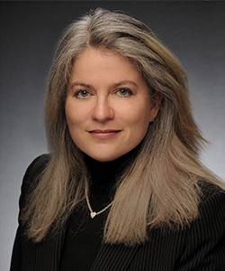 a woman with grey hair is posing for a photo