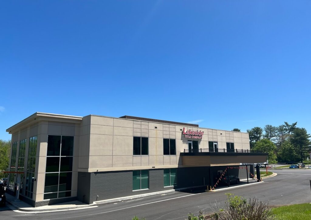 Picture of the outside of an office building with a blue, clear sky.