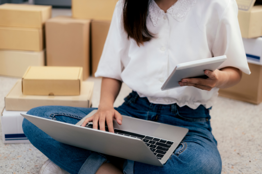 a woman sitting on the floor with a laptop