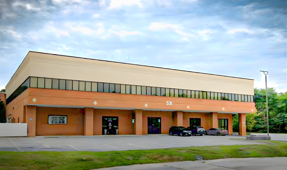 a parking lot with cars parked in front of a building