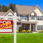 a for sale sign in front of a house
