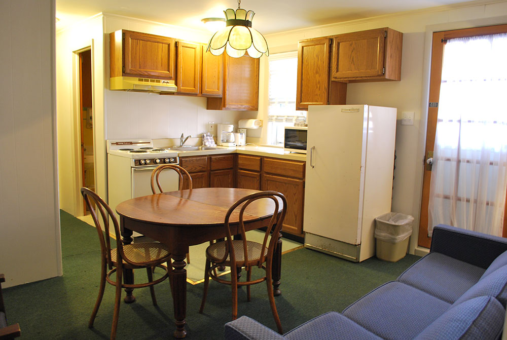 a kitchen with a table and chairs in it