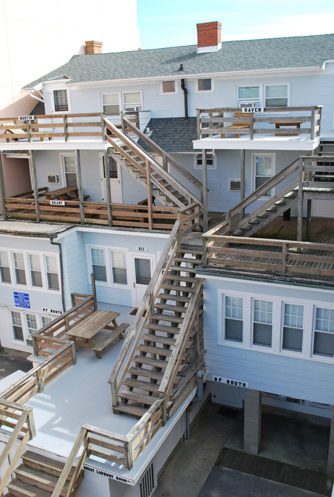 an aerial view of a building with stairs leading up to the second floor