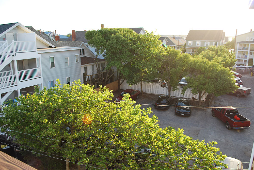 an aerial view of a parking lot with cars parked in it