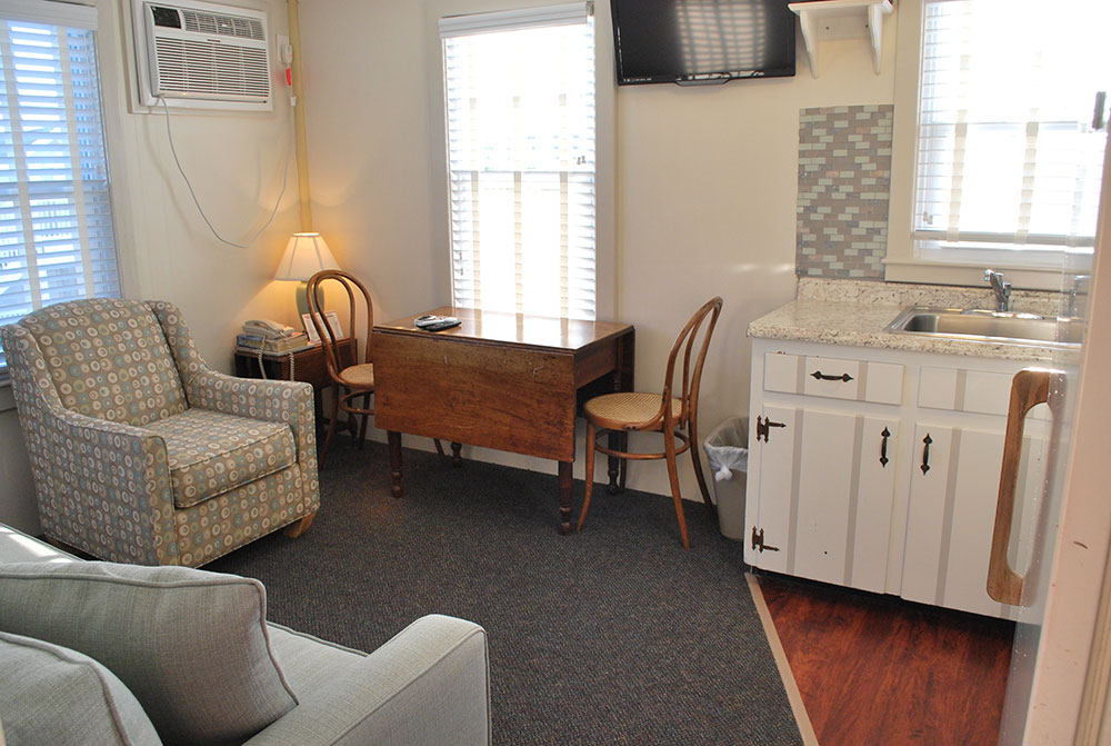 a living room filled with furniture and a flat screen tv