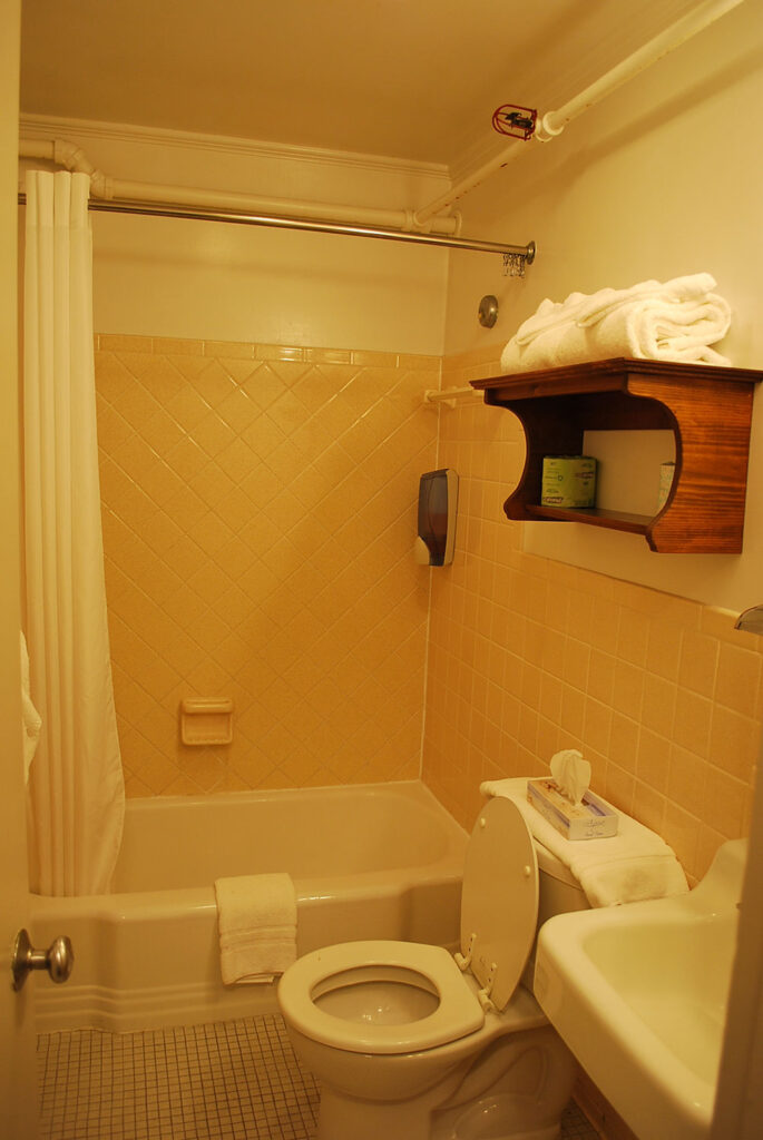 a bathroom with a toilet, sink and bathtub