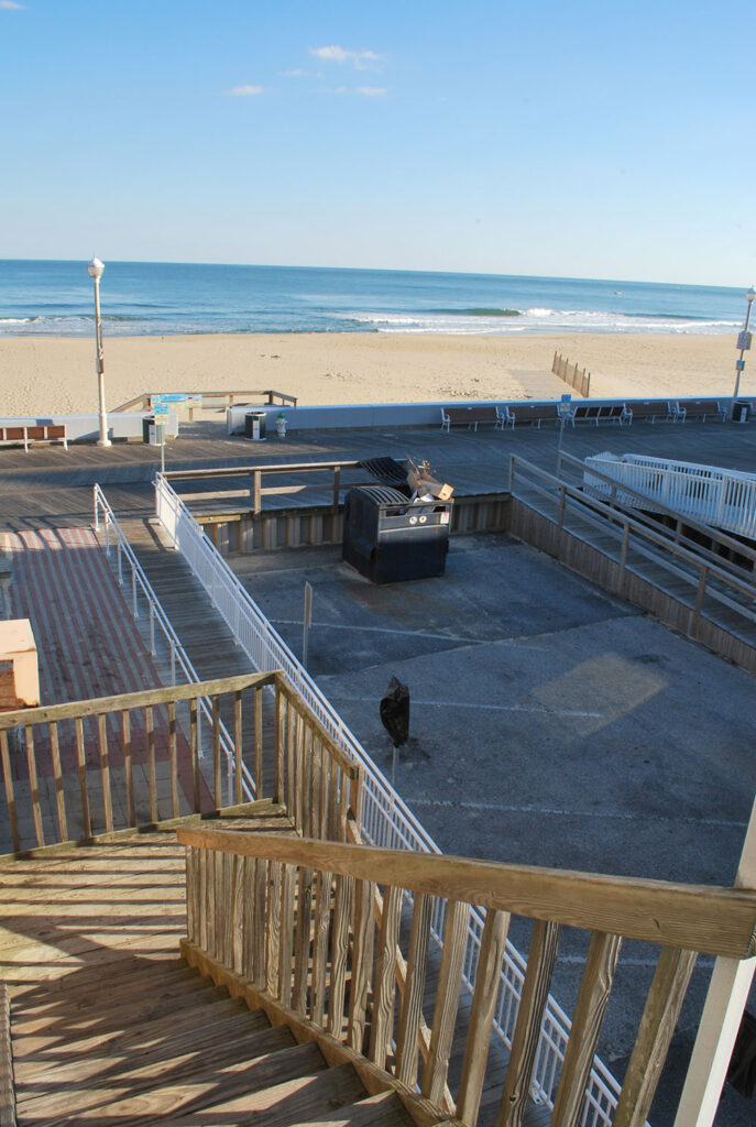 the stairs lead down to the beach from the deck