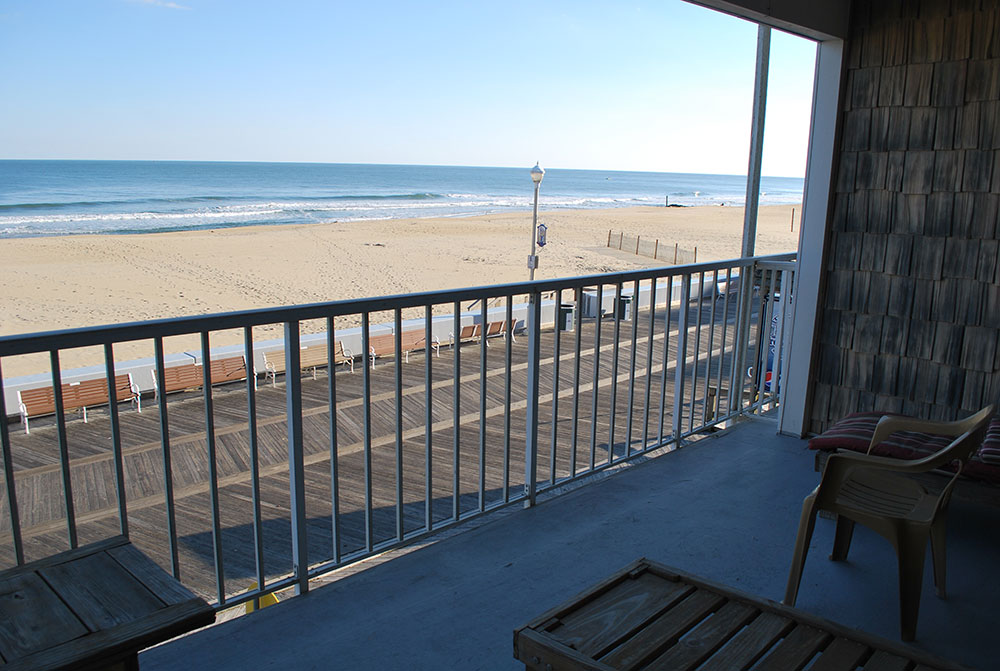 a balcony overlooking the beach and ocean