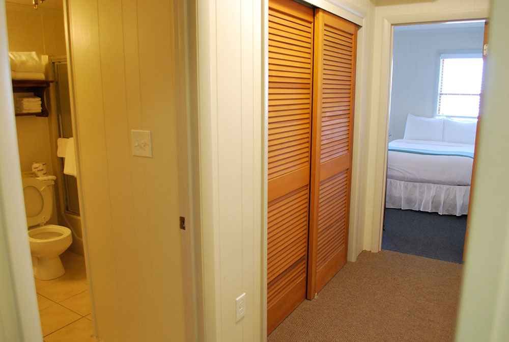 a bathroom with a toilet and a bed in it