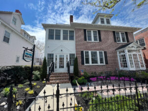 a brick house with a black fence in front of it