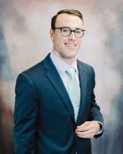 a man in a suit and tie posing for a picture