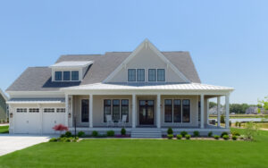 a large white house sitting on top of a lush green field