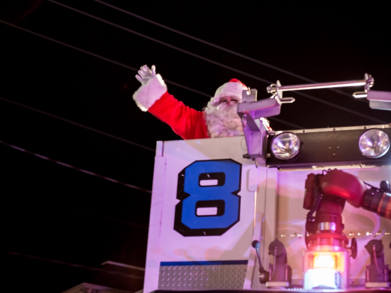 Santa Clause waving in a firetruck